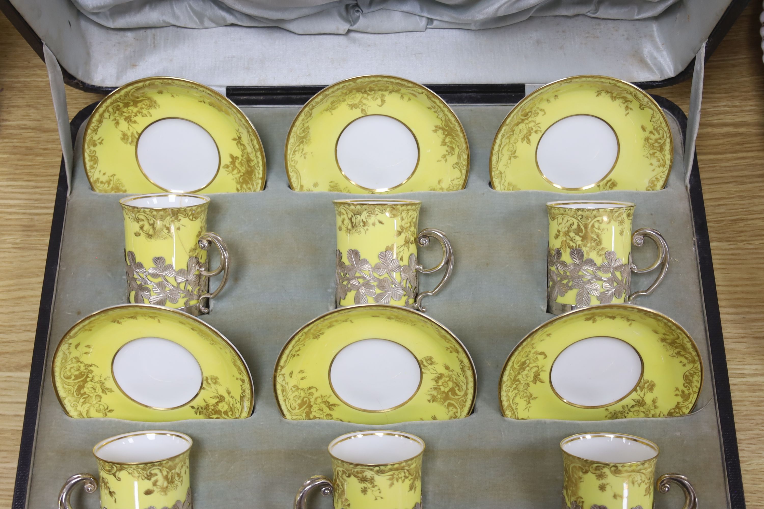 A cased Edwardian part silver mounted Crescent China tea set for six, including six silver teaspoons, Sheffield, 1905.